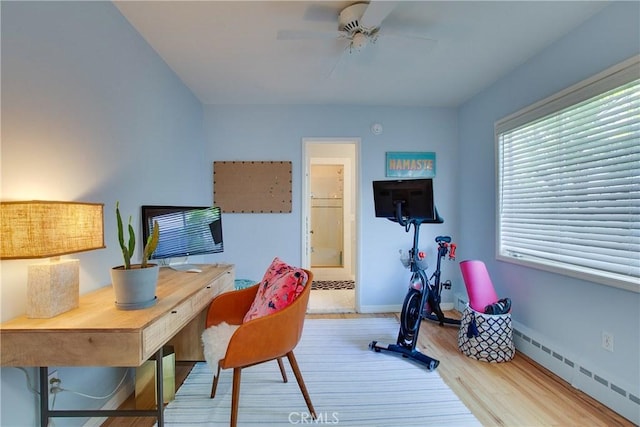 office area with wood finished floors, ceiling fan, baseboard heating, and baseboards
