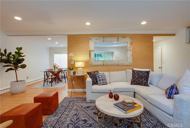living area with wood finished floors, recessed lighting, a baseboard heating unit, and baseboards