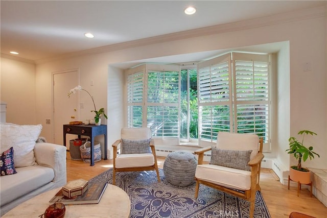 living area with crown molding, recessed lighting, and light wood-style floors