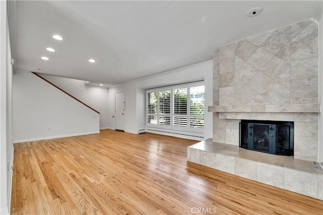 unfurnished living room featuring a fireplace, wood finished floors, recessed lighting, and baseboards