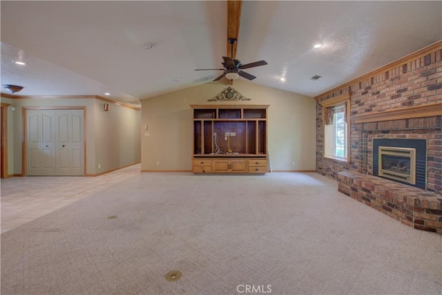 unfurnished living room featuring a brick fireplace, baseboards, a ceiling fan, carpet floors, and vaulted ceiling with beams