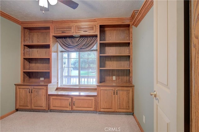 unfurnished office featuring a textured ceiling, ceiling fan, and baseboards