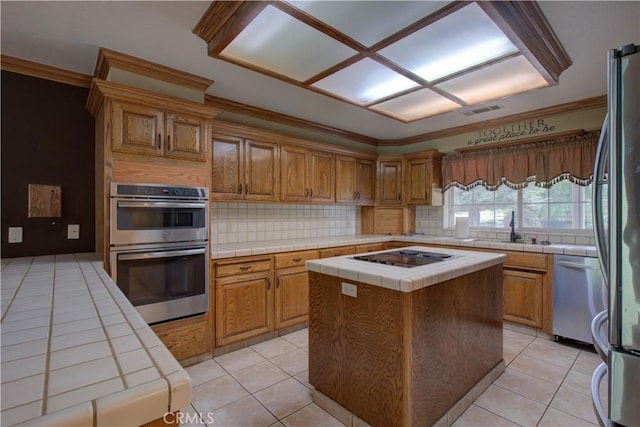 kitchen with light tile patterned floors, backsplash, tile countertops, visible vents, and appliances with stainless steel finishes