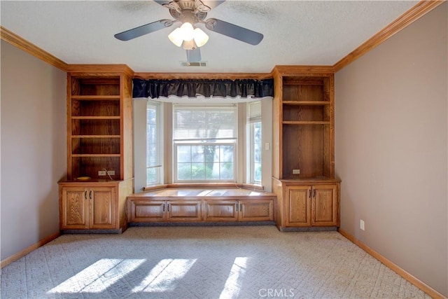 interior space featuring baseboards, visible vents, and crown molding