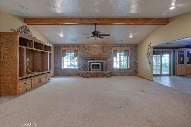 unfurnished living room featuring a ceiling fan, brick wall, and a healthy amount of sunlight