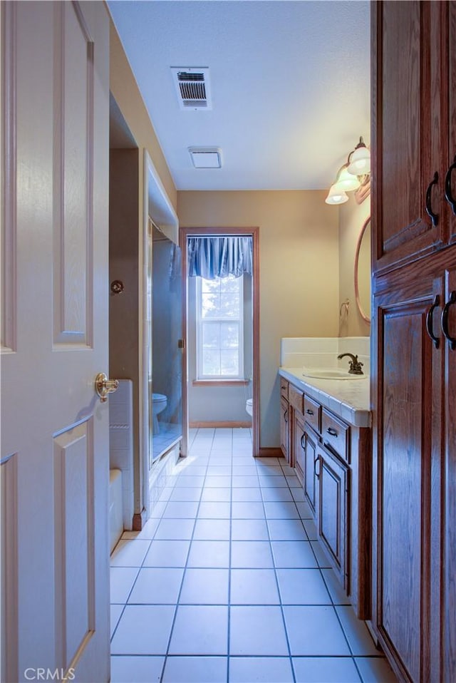 full bath featuring visible vents, a shower stall, toilet, tile patterned floors, and vanity