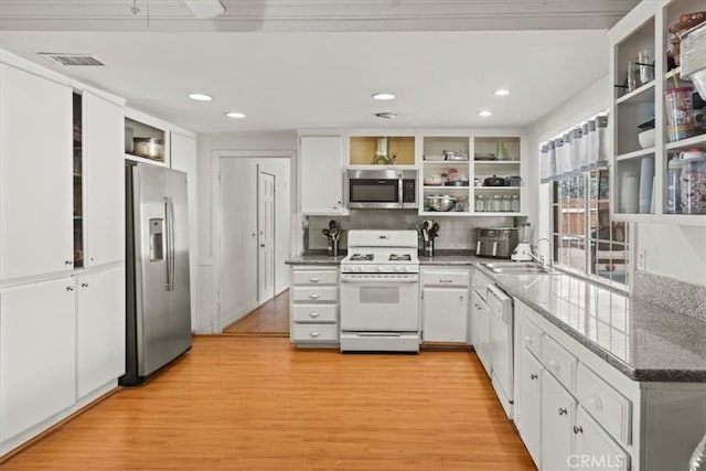 kitchen featuring appliances with stainless steel finishes, light wood finished floors, open shelves, and white cabinets