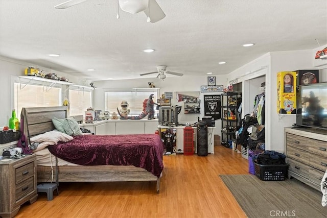 bedroom featuring a textured ceiling, wood finished floors, ornamental molding, and recessed lighting