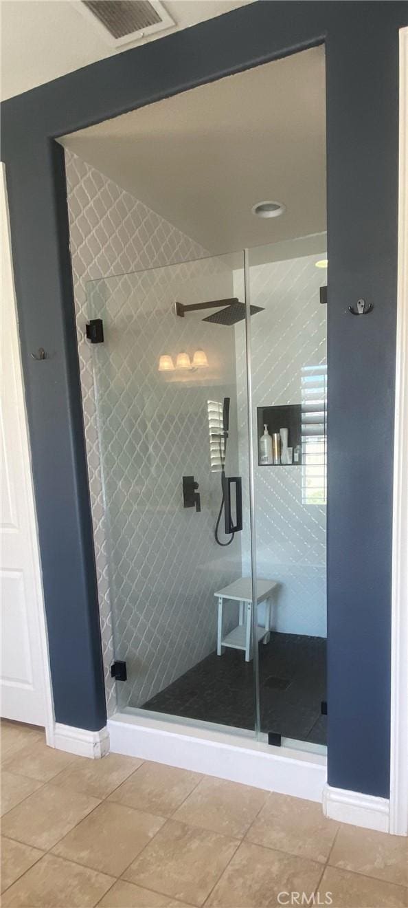 full bath featuring a shower stall, visible vents, and tile patterned floors