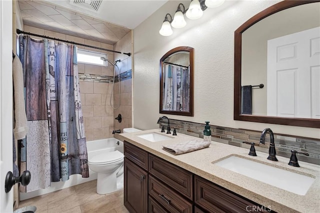 full bathroom featuring visible vents, backsplash, a sink, and double vanity