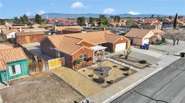 drone / aerial view featuring a residential view and a mountain view