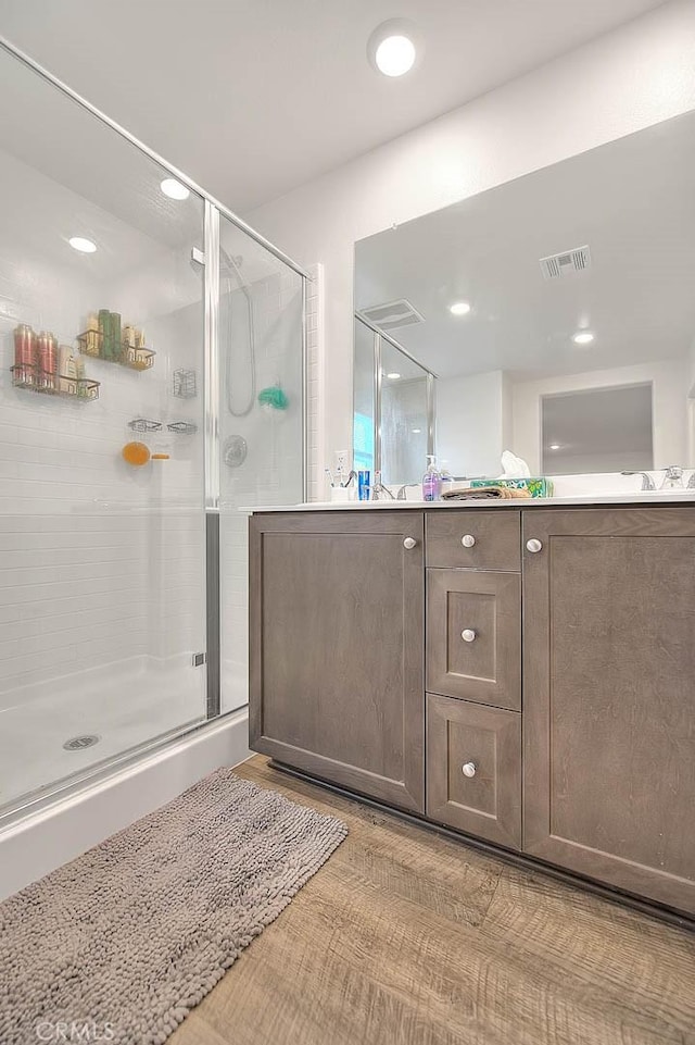 full bathroom featuring a shower stall, visible vents, and vanity