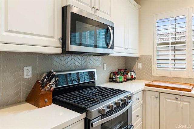 133 Lantana Dr, Stanton, CA 90680 - kitchen featuring appliances with stainless steel finishes, light countertops, white cabinets, and backsplash
