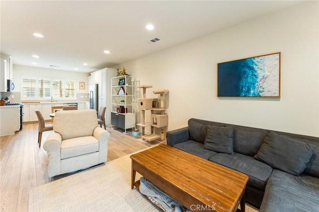 133 Lantana Dr, Stanton, CA 90680 - living area with light wood-type flooring and recessed lighting