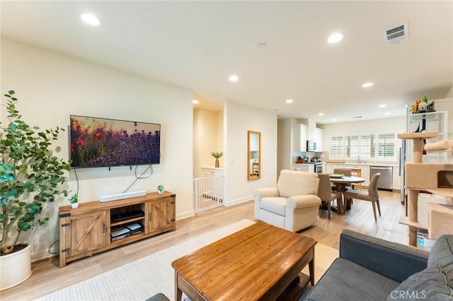 133 Lantana Dr, Stanton, CA 90680 - living room with recessed lighting and light wood-style flooring