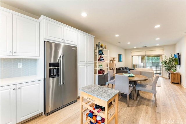 133 Lantana Dr, Stanton, CA 90680 - kitchen with high quality fridge, white cabinetry, light wood-type flooring, recessed lighting, and tasteful backsplash