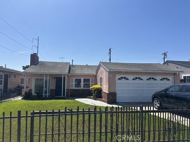 4908 W 109th St, Inglewood, CA 90304 - ranch-style house featuring a garage, a fenced front yard, brick siding, a front lawn, and driveway