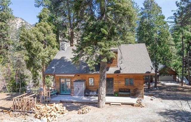 9408 Mill Dr, Forest Falls, CA 92339 - view of front of home with a deck, a shingled roof, and french doors