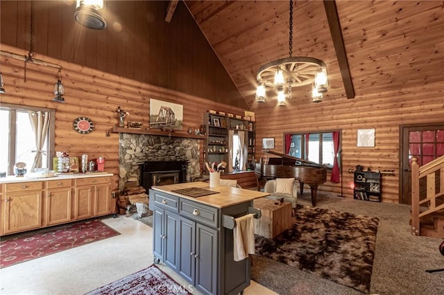 kitchen with beamed ceiling, wood ceiling, log walls, and high vaulted ceiling