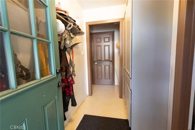 hallway with light floors and baseboards