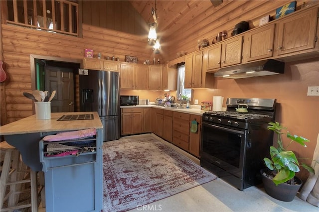 kitchen featuring range with gas cooktop, rustic walls, light countertops, stainless steel refrigerator with ice dispenser, and under cabinet range hood