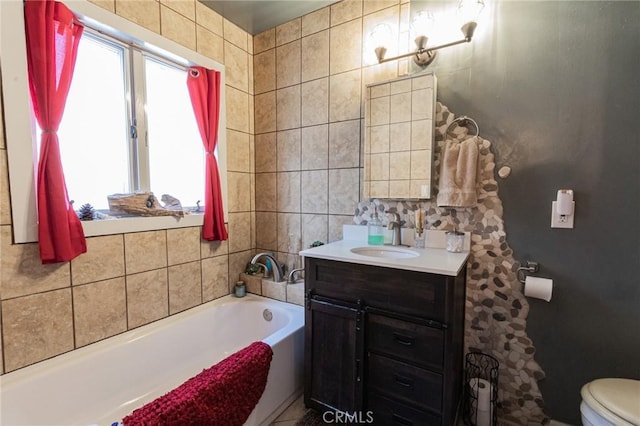bathroom featuring a bath, toilet, and vanity