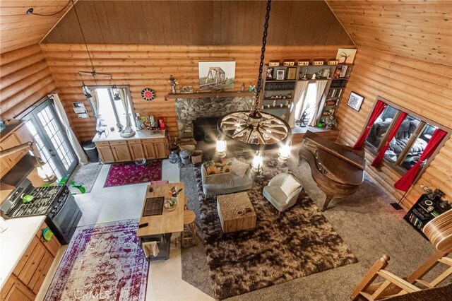 9408 Mill Dr, Forest Falls, CA 92339 - carpeted living room with wood ceiling, lofted ceiling, log walls, and a stone fireplace