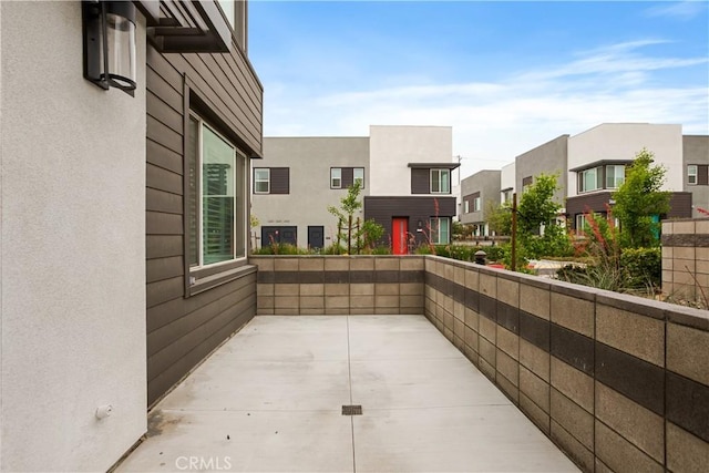 view of patio with a residential view and a balcony