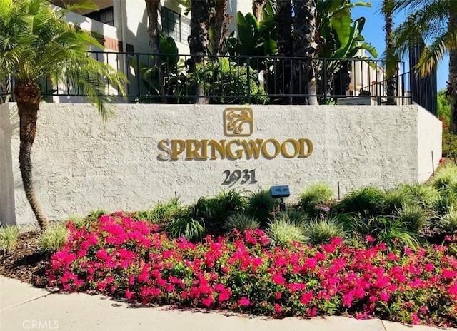 community / neighborhood sign featuring fence
