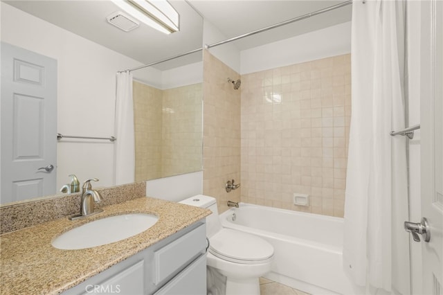 bathroom featuring tile patterned floors, shower / bath combo, vanity, and toilet