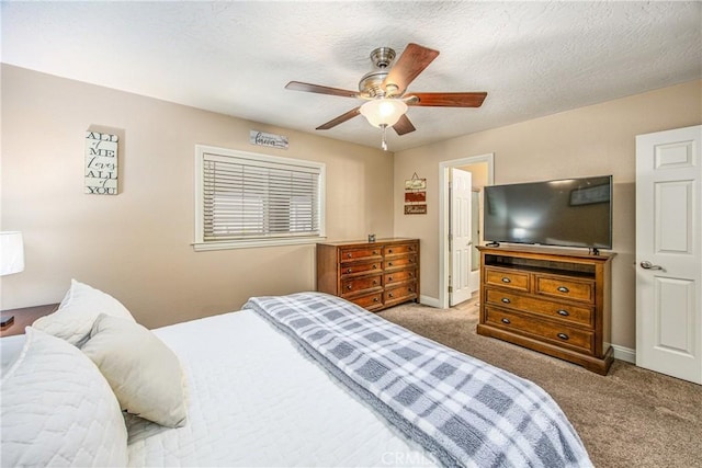 bedroom with baseboards, carpet, a textured ceiling, and a ceiling fan