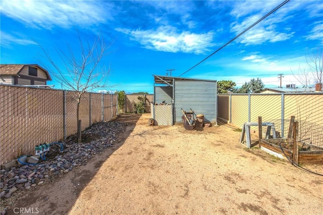 view of yard featuring an outbuilding and a fenced backyard