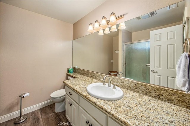 full bath featuring a shower stall, visible vents, toilet, wood finished floors, and baseboards