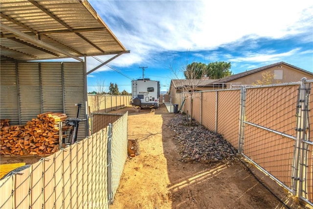 view of side of property featuring fence and a gate