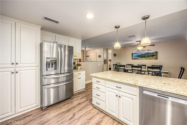 kitchen with light wood-style floors, a ceiling fan, white cabinetry, visible vents, and stainless steel appliances