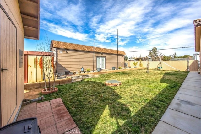 view of yard featuring an outbuilding and a fenced backyard