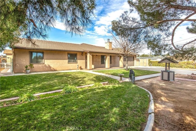 ranch-style home featuring stucco siding, a chimney, driveway, a front yard, and fence