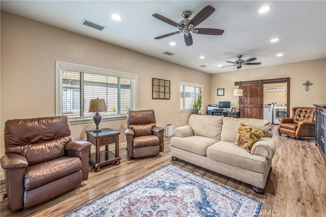 living area featuring visible vents, ceiling fan, recessed lighting, and wood finished floors