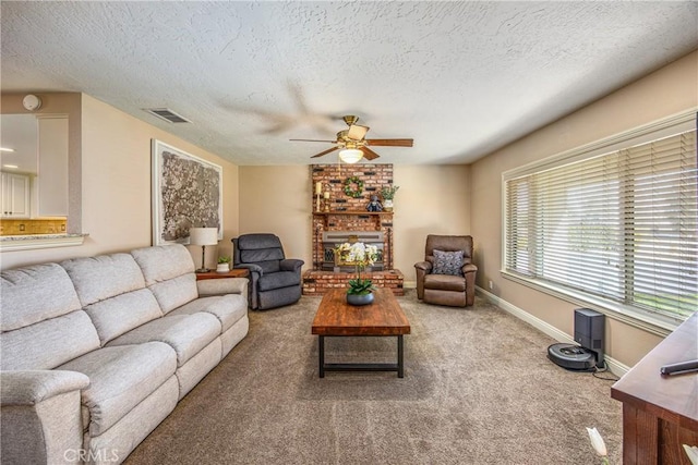 living area featuring baseboards, a textured ceiling, visible vents, ceiling fan, and carpet