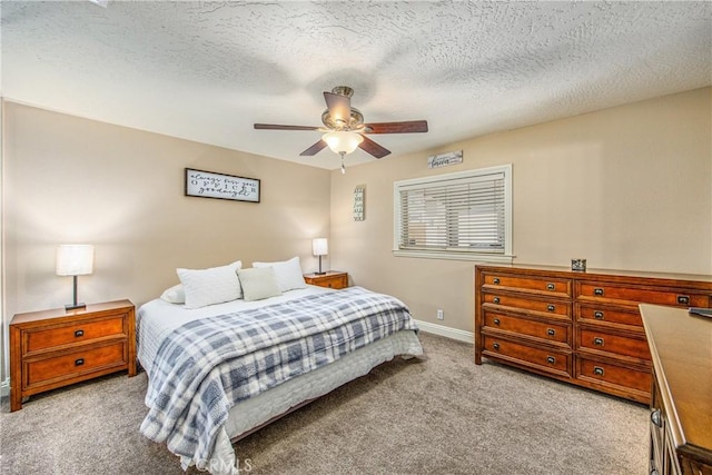 carpeted bedroom featuring a textured ceiling, baseboards, and ceiling fan