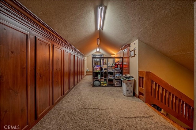 additional living space with a textured ceiling, carpet flooring, and vaulted ceiling