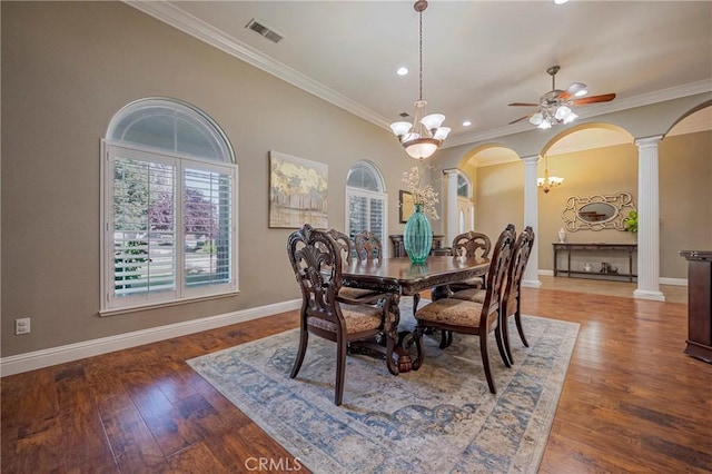 dining room with visible vents, decorative columns, arched walkways, and crown molding