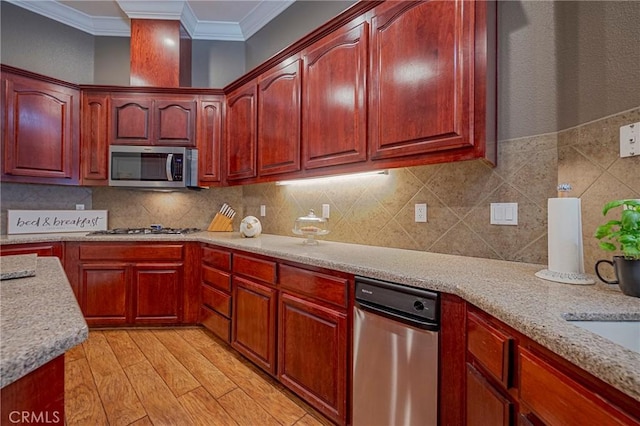 kitchen featuring stainless steel appliances, dark brown cabinets, light wood finished floors, ornamental molding, and backsplash