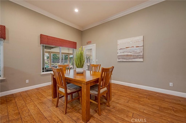dining room featuring light wood-style flooring, recessed lighting, ornamental molding, and baseboards