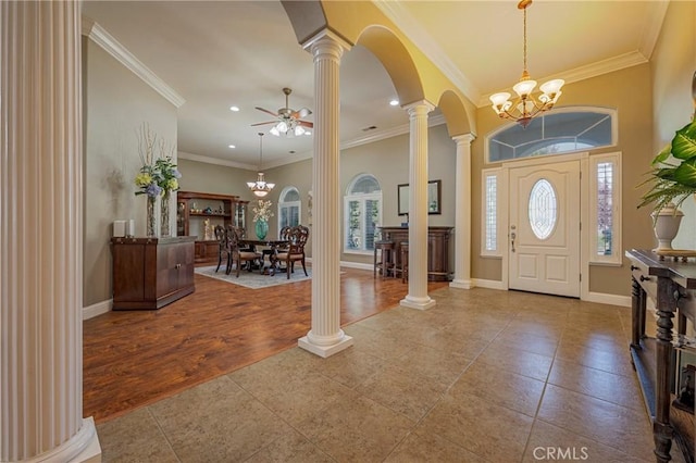 tiled entryway with recessed lighting, arched walkways, decorative columns, and a healthy amount of sunlight