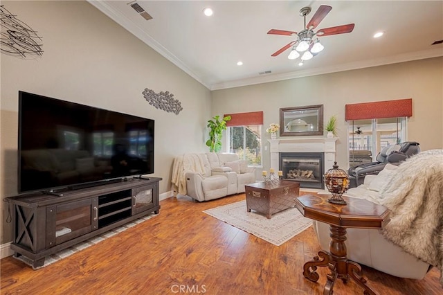 living room featuring a wealth of natural light, wood finished floors, and ceiling fan