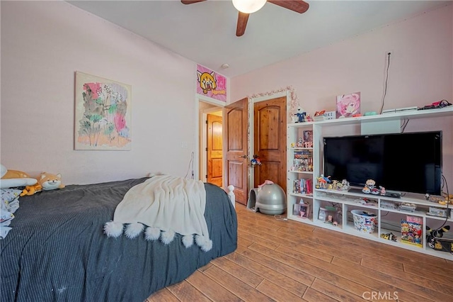bedroom with wood finished floors and a ceiling fan