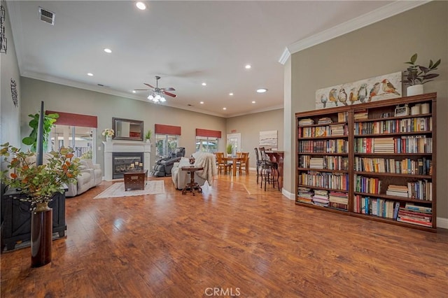 interior space with a wealth of natural light, recessed lighting, wood finished floors, and a ceiling fan