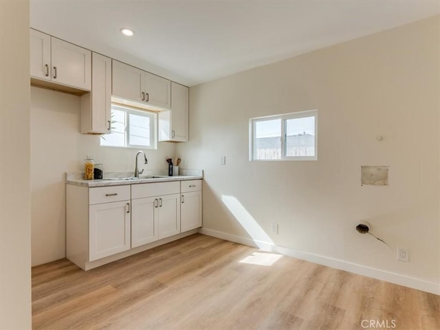 1912 8th St, Los Osos, CA 93402 - kitchen featuring light countertops, a healthy amount of sunlight, a sink, and light wood finished floors