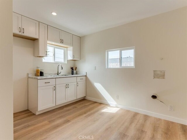 1912 8th St, Los Osos, CA 93402 - kitchen featuring light wood finished floors, plenty of natural light, light countertops, white cabinetry, and recessed lighting